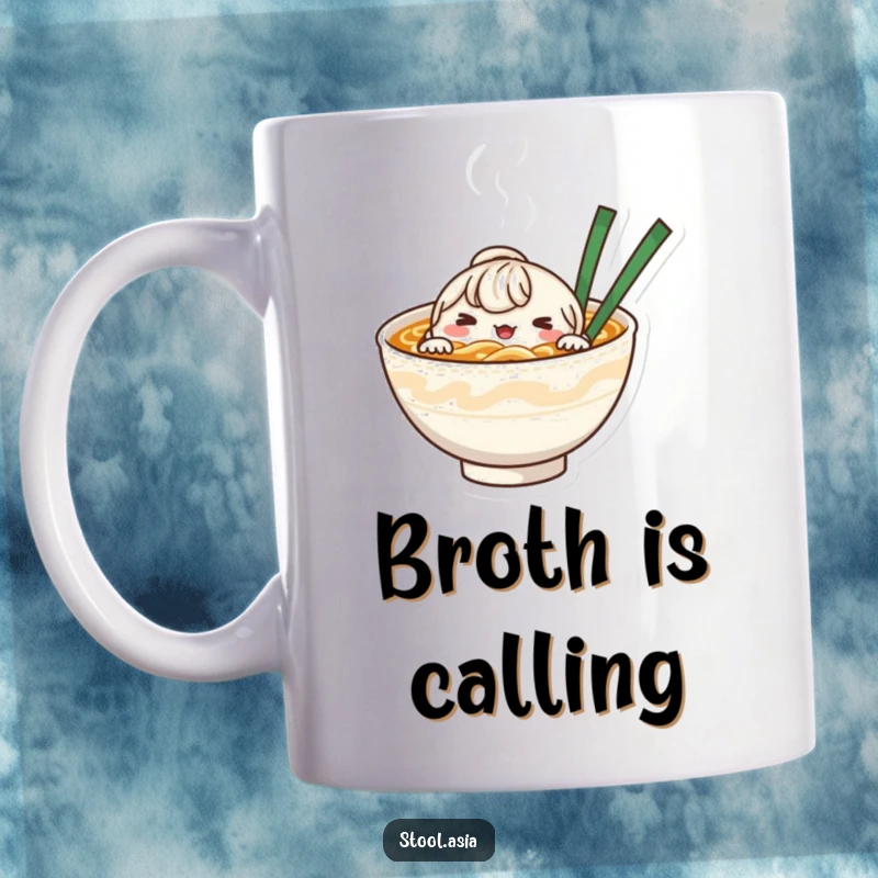 Funny whimsical noodle bowl character peeking from its steaming broth, depicted on a mug for soup enthusiasts.